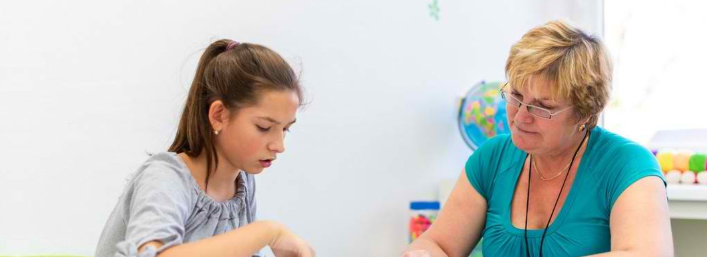 woman teaching a kid